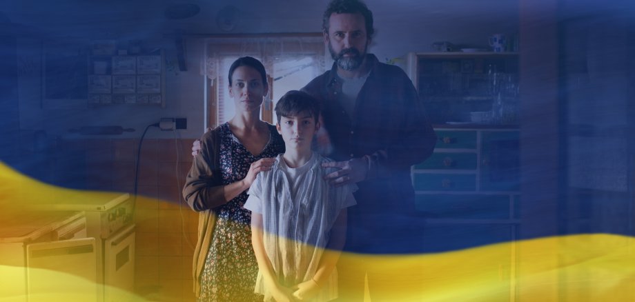 Double exposure of poor family with small daughter and Ukrainian flag.