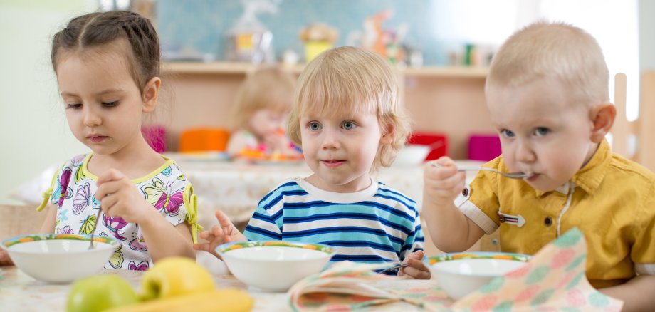 Kids eating in kindergarten or day care centre Kids eating in kindergarten or day care centre