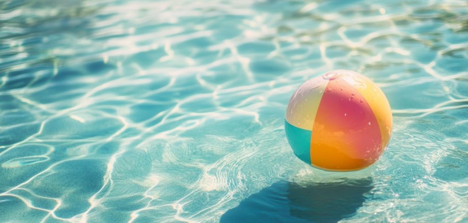 Colorful beach ball in pool water (1)